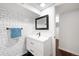 Bathroom featuring black and white tile, a white vanity and subway tile at 3055 S Bannock St, Englewood, CO 80110