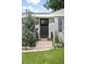 A beautifully landscaped front entrance, complete with a modern door, stone steps, and colorful flowerbeds at 3055 S Bannock St, Englewood, CO 80110