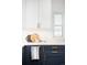 Bright kitchen features white countertops, navy cabinets, and gold hardware at 3055 S Bannock St, Englewood, CO 80110