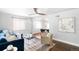 Open-concept living room with hardwood floors, comfortable seating, and ample natural light at 3055 S Bannock St, Englewood, CO 80110