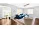 Cozy living room featuring a comfortable sectional, ample windows, and hardwood floors at 3055 S Bannock St, Englewood, CO 80110