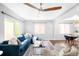 Bright living room with a large sectional sofa, ceiling fan and lots of natural light at 3055 S Bannock St, Englewood, CO 80110