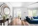 Inviting living room featuring hardwood floors, a large mirror, and plenty of natural light at 3055 S Bannock St, Englewood, CO 80110