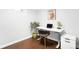 Office space with hardwood floors, an adjustable desk, and natural light at 3055 S Bannock St, Englewood, CO 80110