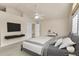 Serene bedroom featuring neutral tones, modern furniture, and a ceiling fan at 4042 E Hinsdale Cir, Centennial, CO 80122