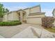 Charming home with a two-car garage, stone accents, and a well-maintained lawn, enhancing curb appeal at 4042 E Hinsdale Cir, Centennial, CO 80122