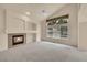 Inviting living area with vaulted ceilings, a cozy fireplace, and a large window framing outdoor views at 4042 E Hinsdale Cir, Centennial, CO 80122