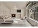 Bright and open living room featuring a fireplace, vaulted ceiling, and large windows at 4042 E Hinsdale Cir, Centennial, CO 80122