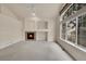 Bright living area featuring a fireplace, vaulted ceilings, and expansive windows that provide ample natural light at 4042 E Hinsdale Cir, Centennial, CO 80122
