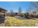 Spacious backyard with play structure, swing set, and patio for outdoor activities and relaxation at 5224 Snow Goose St, Brighton, CO 80601