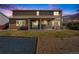 Backyard with a covered patio, a lush lawn, and a gravel area for activities and play at 5224 Snow Goose St, Brighton, CO 80601