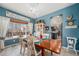 Bright dining room with a wood table, chandelier, and large window view at 5224 Snow Goose St, Brighton, CO 80601