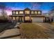 Charming two-story brick home featuring a covered porch, attached two car garage, and landscaped front yard at 5224 Snow Goose St, Brighton, CO 80601