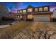 Charming two-story brick home with a covered front porch and well-maintained lawn and a two car garage at 5224 Snow Goose St, Brighton, CO 80601
