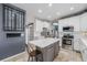 Modern kitchen featuring white cabinets, stainless steel appliances, and a gray island at 5224 Snow Goose St, Brighton, CO 80601