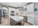 Bright kitchen with white cabinets, quartz counters, stainless appliances, and an island, offering ample space and modern style at 5224 Snow Goose St, Brighton, CO 80601