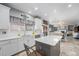 Modern kitchen featuring white cabinets, stainless steel appliances, and a gray island at 5224 Snow Goose St, Brighton, CO 80601