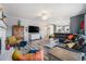 Large living room with hardwood floors, fireplace, large black sectional, and open to kitchen at 5224 Snow Goose St, Brighton, CO 80601
