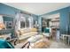 Bright living room area featuring large windows and an adjacent dining area at 5224 Snow Goose St, Brighton, CO 80601