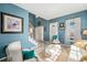 Bright living room featuring large windows, blue walls and tile floors at 5224 Snow Goose St, Brighton, CO 80601