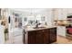 Modern kitchen with island, stainless steel appliances and access to Gathering room at 1337 N Ford St, Golden, CO 80403