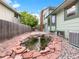 Picturesque backyard with a decorative pond and privacy fence at 1460 Belmont Dr, Longmont, CO 80503
