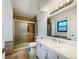 Bright bathroom features tile floors, shower, soaking tub, and modern vanity at 1460 Belmont Dr, Longmont, CO 80503