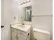 Cozy bathroom featuring a vanity with a beige sink and a mirrored wall cabinet at 1460 Belmont Dr, Longmont, CO 80503