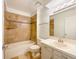 Bathroom featuring tile, bathtub and shower, vanity, and toilet at 1460 Belmont Dr, Longmont, CO 80503