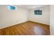 Empty bedroom with a hardwood floors, neutral paint, and bright window at 1460 Belmont Dr, Longmont, CO 80503