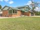 Charming two-story home with a brick exterior and a well-manicured front lawn, showcasing curb appeal at 1460 Belmont Dr, Longmont, CO 80503