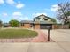 Charming two-story home with brick facade, dormer windows, well-manicured lawn and two car garage at 1460 Belmont Dr, Longmont, CO 80503