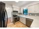 This updated kitchen offers stainless appliances, and white cabinets at 1460 Belmont Dr, Longmont, CO 80503