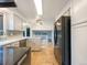 This kitchen features white cabinets, stainless appliances and stone floors at 1460 Belmont Dr, Longmont, CO 80503