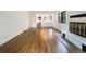 Bright living room with wood floors, fireplace, and staircase to the upper level at 1460 Belmont Dr, Longmont, CO 80503