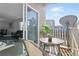 Enjoy the view from this cozy balcony with outdoor seating and a glimpse of the living room indoors at 7375 E Quincy Ave # 204, Denver, CO 80237