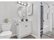 Clean bathroom with updated vanity, mirror, and shower/tub combination at 7375 E Quincy Ave # 204, Denver, CO 80237
