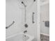 Clean bathroom with shower/tub combo and grab bars at 7375 E Quincy Ave # 204, Denver, CO 80237