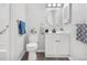 Updated bathroom featuring a new vanity, round mirror, and modern fixtures at 7375 E Quincy Ave # 204, Denver, CO 80237