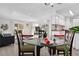 Bright dining area features a glass table, seating for four, and an adjacent kitchen with white cabinets and modern appliances at 7375 E Quincy Ave # 204, Denver, CO 80237
