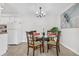 Bright dining room features a glass table, wood chairs, modern light fixture, and stylish decor at 7375 E Quincy Ave # 204, Denver, CO 80237