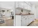 Kitchen with white cabinets and a breakfast bar at 7375 E Quincy Ave # 204, Denver, CO 80237