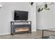 Comfortable living room featuring a TV with fireplace below, with an open concept floorplan at 7375 E Quincy Ave # 204, Denver, CO 80237