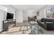 Open living and dining area with hardwood floors and fireplace feature at 7375 E Quincy Ave # 204, Denver, CO 80237