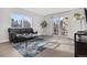 The living room features an expansive window, sliding doors to a balcony, and modern decor at 7375 E Quincy Ave # 204, Denver, CO 80237