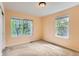 Inviting bedroom filled with natural light from two large windows with backyard views at 511 Noel Ave, Longmont, CO 80501
