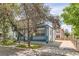 This two-story home has a welcoming front porch, long driveway, and well-maintained yard at 511 Noel Ave, Longmont, CO 80501