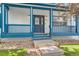 Close-up of the home's charming front porch with decorative railings and a stylish front door at 511 Noel Ave, Longmont, CO 80501