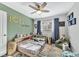 Comfortable bedroom with personalized decor, ceiling fan, ample natural light and wood look flooring at 15592 E Kenyon Ave, Aurora, CO 80013
