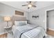 Bright bedroom with natural light, ceiling fan, and plush bedding. Classic marble side table with decor at 15592 E Kenyon Ave, Aurora, CO 80013